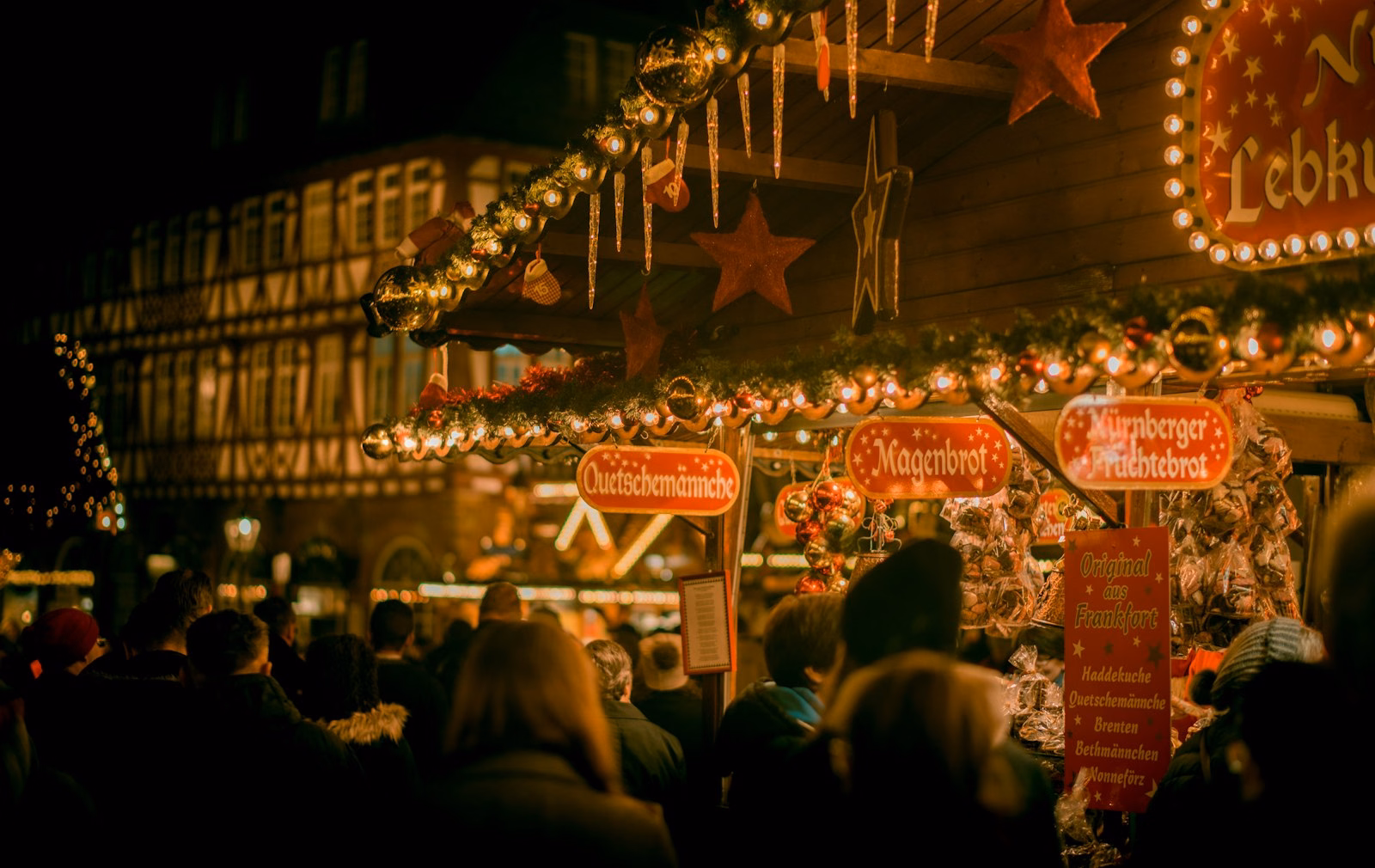 Visitors at wooden stalls like those at the Esslingen Christmas market