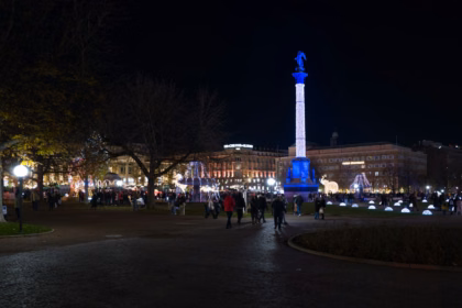 Visitors walking through the Stuttgart Christmas market at night