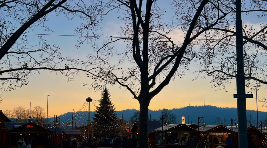 People gathered around a decorated Christmas tree in Zurich